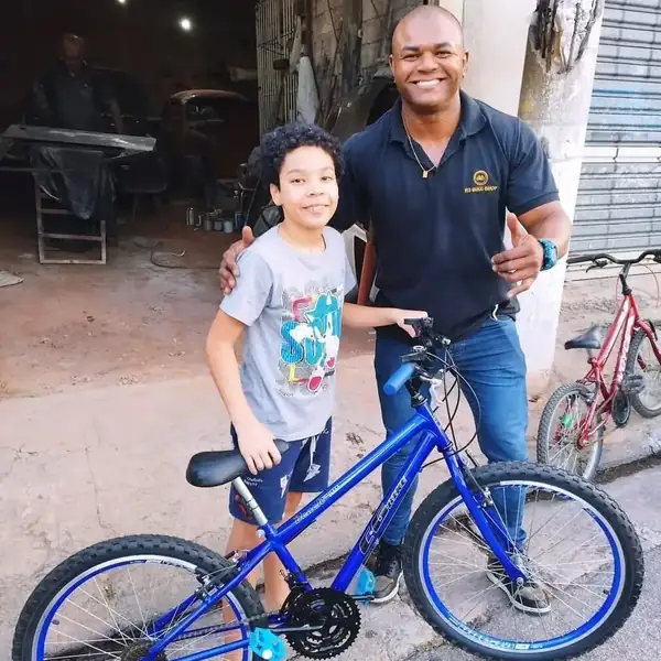 Cliente e criança com bicicleta azul entregue pela loja